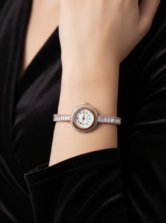 Close-up of a wrist wearing a silver bracelet with a watch face on a black background