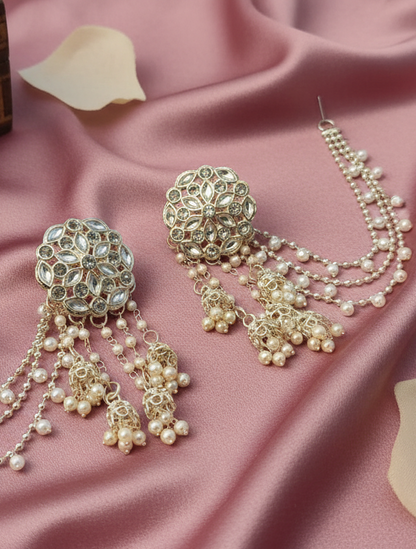 Jewelry set with necklace and earrings on a pink fabric background