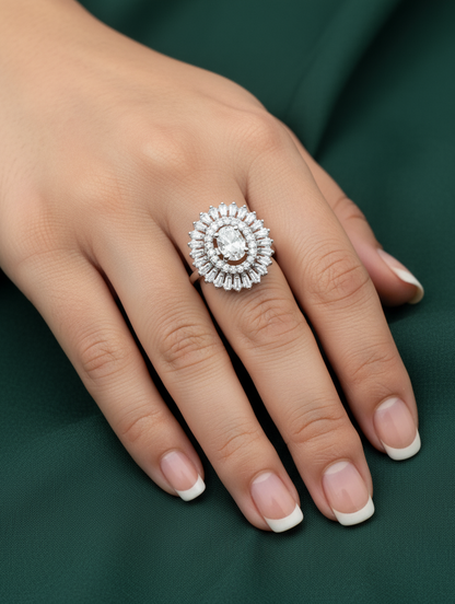 Close-up of a hand wearing a diamond ring on a dark green background